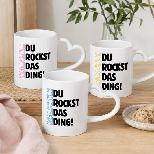 Geschenk zum Start in die Realschule mit Motivation für jeden Tag. Keramiktasse mit herzförmigem Henkel: Realschule Du rockst…